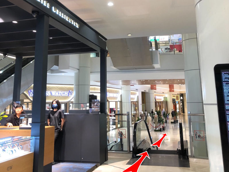 Use the escalator next to Daniel Wellington
