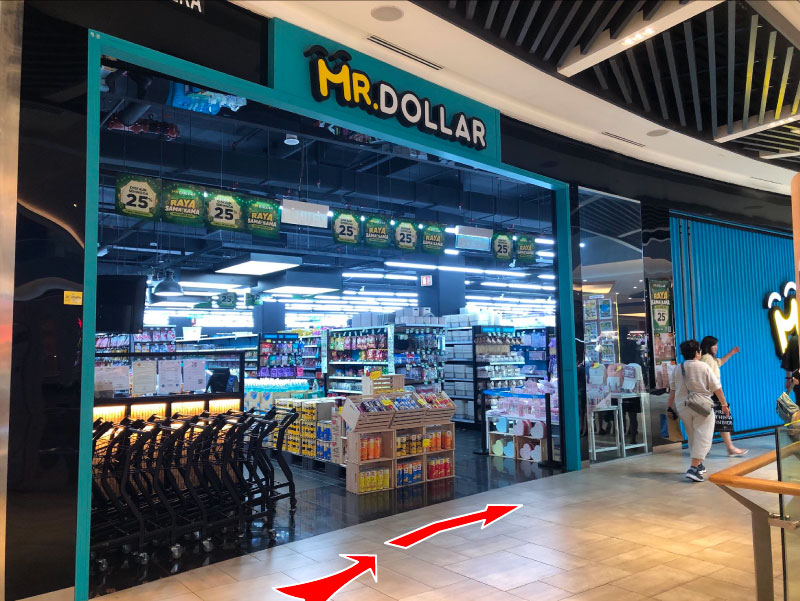 Turn to right after escalator. Mr Dollar on your left.